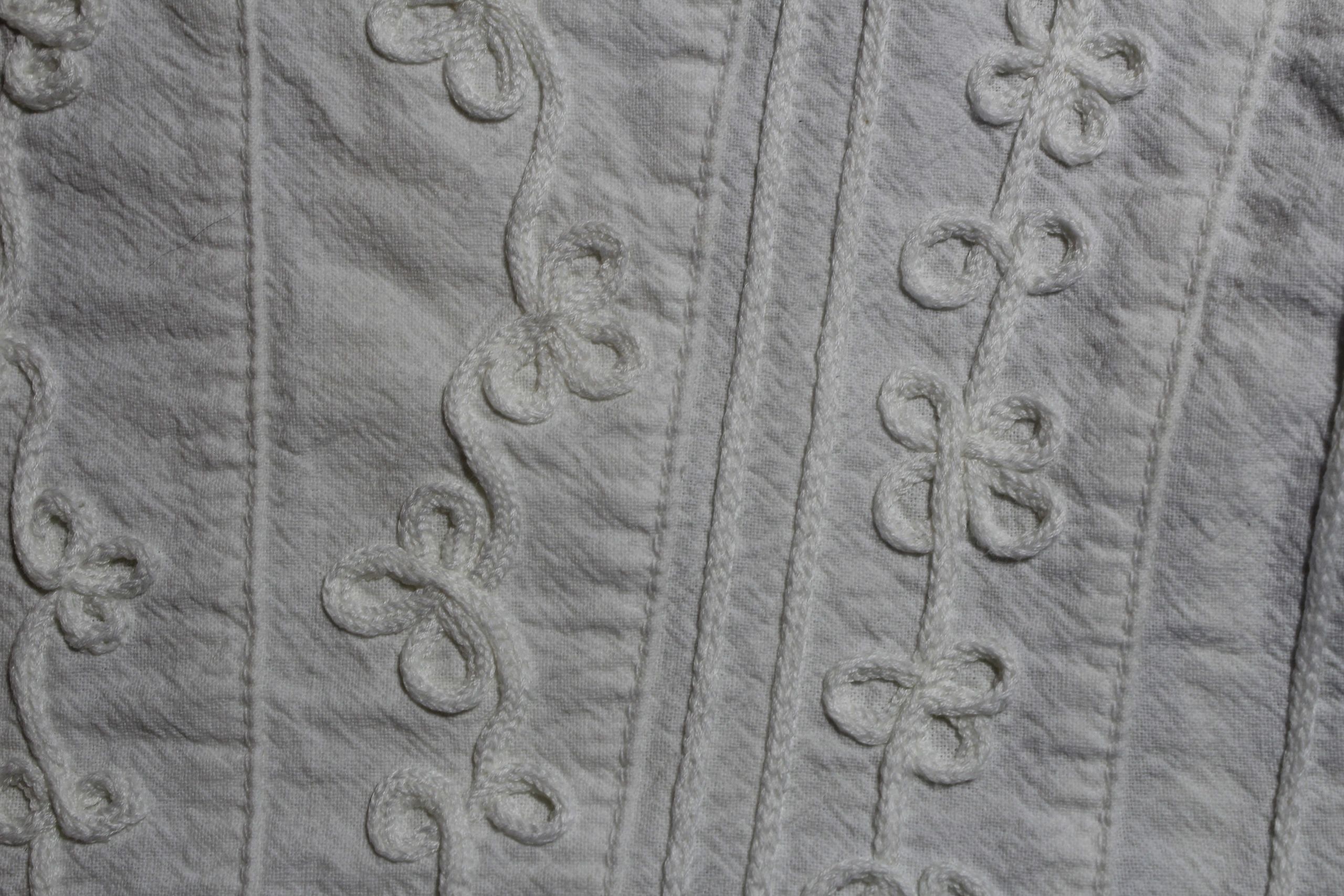Close-up of detailed embroidery on a white shirt